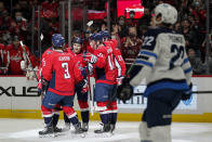 Washington Capitals' Dmitry Orlov (9) celebrates his goal with teammates in the second period of an NHL hockey game against the Winnipeg Jets, Tuesday, Jan. 18, 2022, in Washington. (AP Photo/Patrick Semansky)