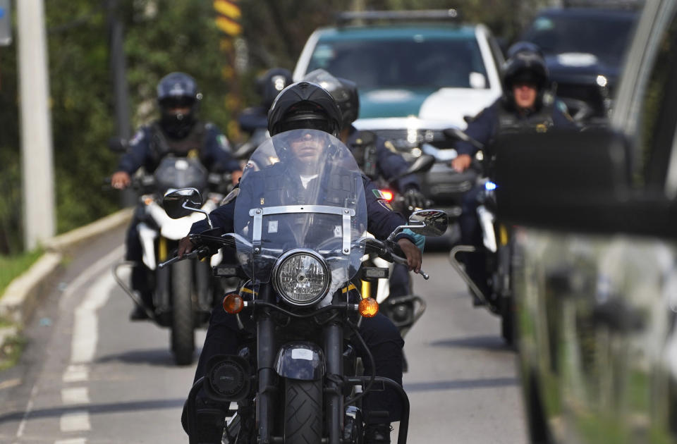 Police drive away after confrontations with what they claim were groups of criminals that left several in their ranks wounded, and more than a dozen persons detained, in Tupilejo, on the outskirts of Mexico City, Tuesday, July 12, 2022. (AP Photo/Marco Ugarte)