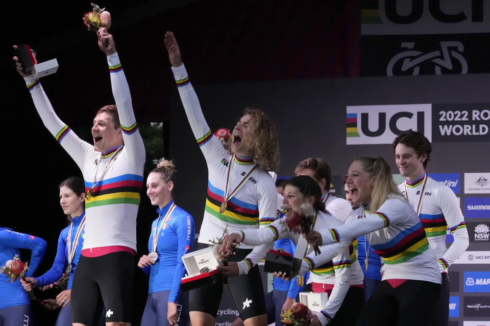 Members of the Swiss team celebrate their gold medal from the team time trial mixed relay at the world road cycling championships in Wollongong, Australia, Wednesday, Sept. 21, 2022. (AP Photo/Rick Rycroft)