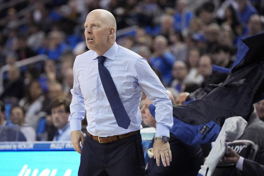 UCLA head coach Mick Cronin tosses his jacket as he yells at a referee during the first half.
