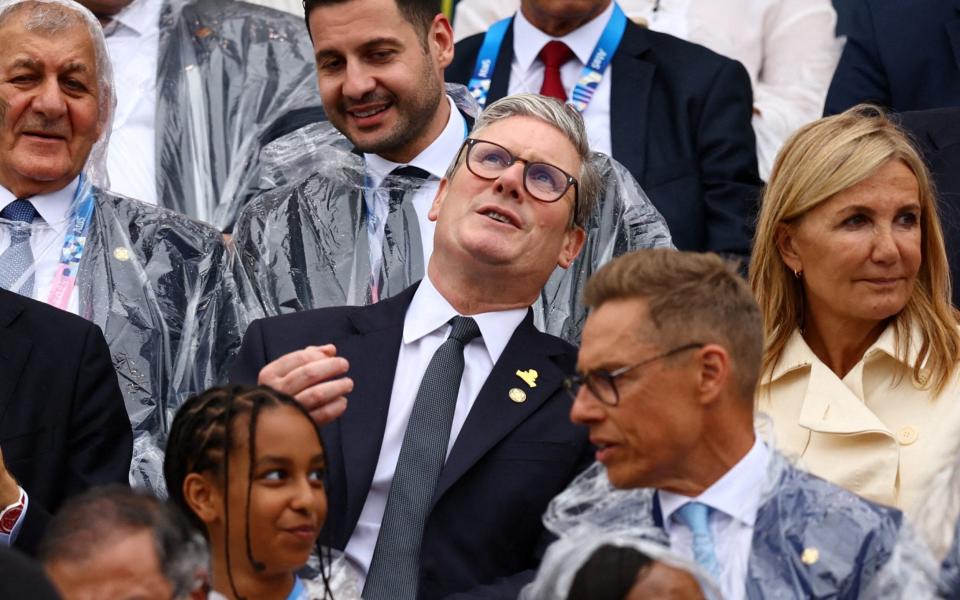 Sir Keir Starmer looks up at the overcast sky at the opening ceremony of the Paris 2024 Olympics