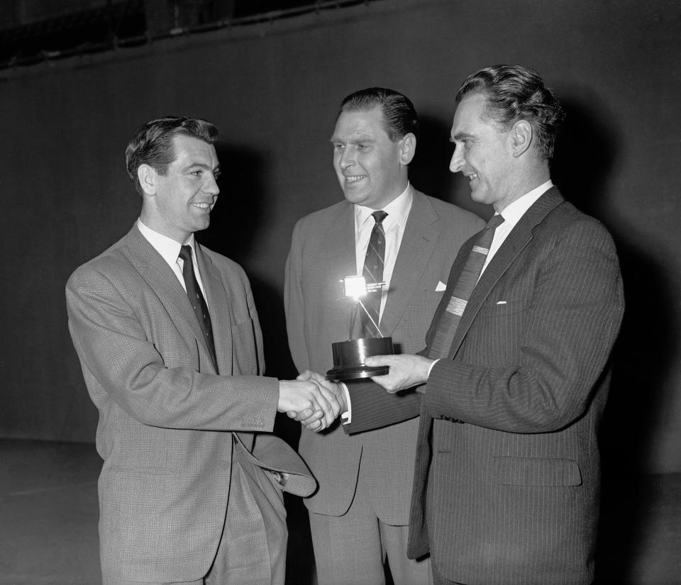Fulham footballer Johnny Haynes (left) receives the BBC junior sportsview award trophy.