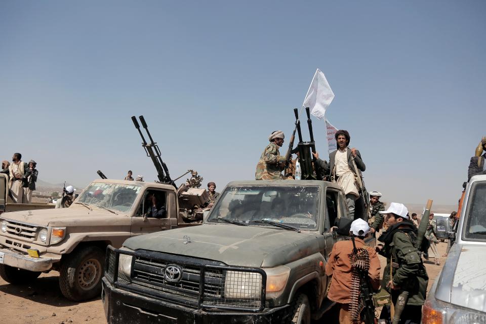 Houthi fighters man heavy machine guns mounted on vehicles at a rally in support of Palestinians in the Gaza (Getty Images)