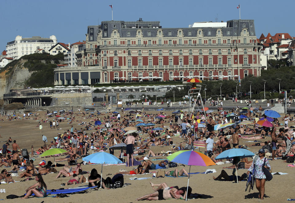 FILE - People sunbathe on Biarritz' beach, southwestern France, Oct. 7, 2023. October was the fifth straight month that Earth set a record for the hottest month in recorded history. (AP Photo Bob Edme, File)