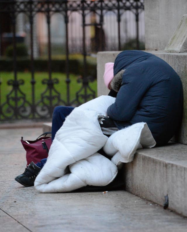 Homeless people sleep on the plinth of the Ferdinand Foch equestrian statue in Victoria, London (Nick Ansell/PA)