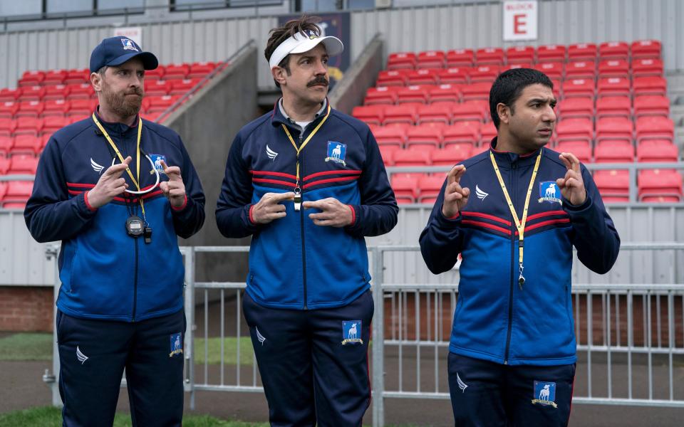 Brendan Hunt as Coach Beard, Jason Sudeikis as Ted Lasso and Nick Mohammed as Nate Shelley in “Ted Lasso” Season 2.