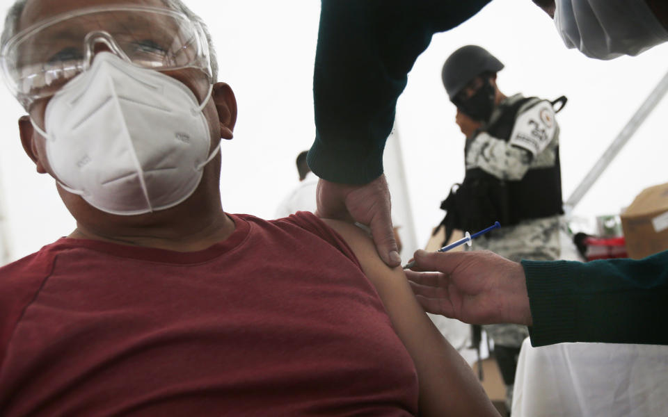 An elderly man gets his Sinovac Biotech COVID-19 vaccine at the Americas sports center in Ecatepec, a borough on the outskirts of Mexico City, Tuesday, Feb. 23, 2021. (Foto AP/Marco Ugarte