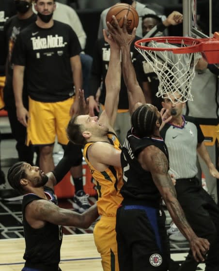 Clippers forward Kawhi Leonard #2 blocks the shot of Jazz forward Bojan Bogdanovic during Game 4 on June 14, 2021, in L.A.