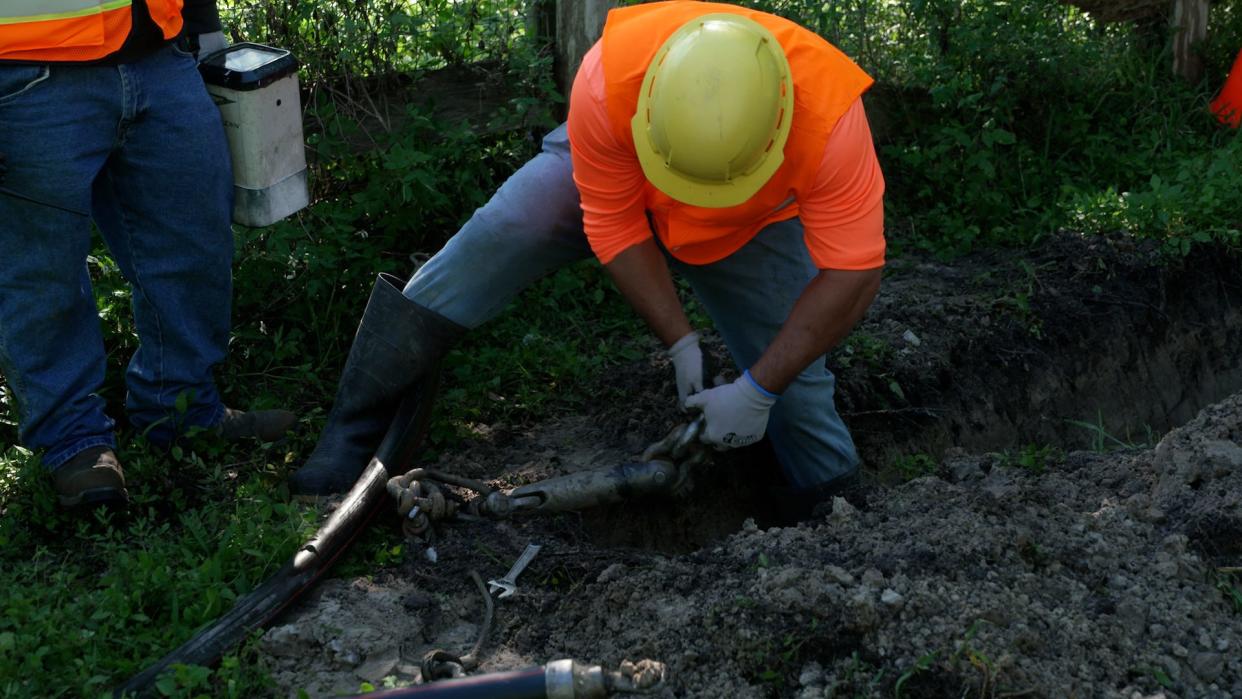 A Florida Power & Light crew member demonstrates the process of moving power lines underground on February 21, 2024, in Jupiter Farms, Fla.