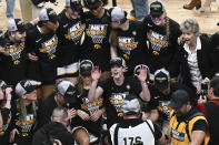 Iowa guard Caitlin Clark, center, poses with teammates for a photo after Iowa defeated LSU in an Elite Eight round college basketball game during the NCAA Tournament, Monday, April 1, 2024, in Albany, N.Y. (AP Photo/Hans Pennink)