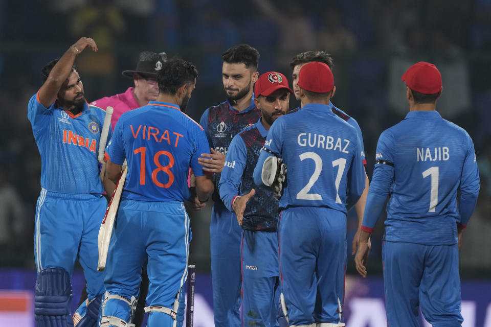 India's Virat Kohli and Shreyas Iyer shake hands with Afghanistan players following their eight wickets win in the ICC Men's Cricket World Cup match in New Delhi, India, Wednesday, Oct. 11, 2023. (AP Photo/Manish Swarup)