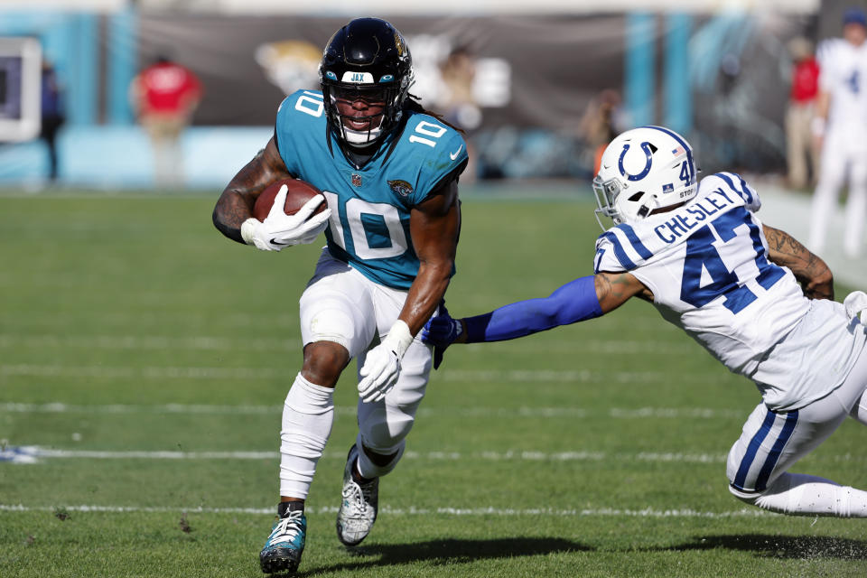 Jacksonville Jaguars wide receiver Laviska Shenault Jr. (10) makes a move to get around Indianapolis Colts cornerback Anthony Chesley (47) during the first half of an NFL football game, Sunday, Jan. 9, 2022, in Jacksonville, Fla. (AP Photo/Stephen B. Morton)