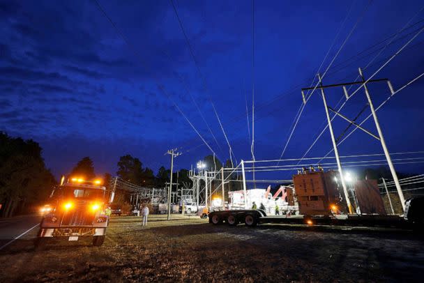 PHOTO: Duke Energy personnel work to restore power at a crippled electrical substation that the workers said was hit by gunfire after the Moore County Sheriff said that vandalism caused a mass power outage, in Carthage, North Carolina, Dec. 4, 2022. (Jonathan Drake/Reuters)