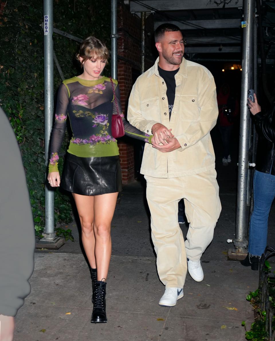Taylor Swift and Travis Kelce holding hands in New York City.