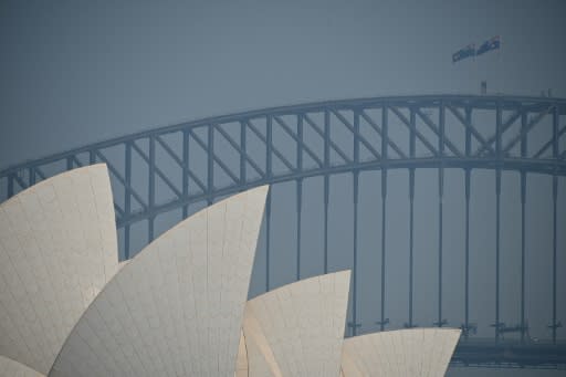 The Sydney Opera House and Harbour Bridge are seen through a smokey haze which blankets Sydney