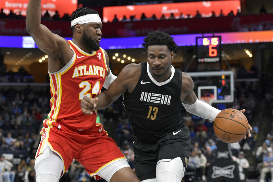 Memphis Grizzlies forward Jaren Jackson Jr. (13) drives against Atlanta Hawks forward Bruno Fernando (24) during the first half of an NBA basketball game Friday, March 8, 2024, in Memphis, Tenn. (AP Photo/Brandon Dill)