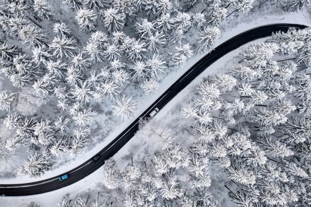 In this photo taken Thursday with a drone, a road stretches through the snow-covered Thuringian Forest in Ilmenau, Germany. (Photo: Michael Reichel/dpa via AP)