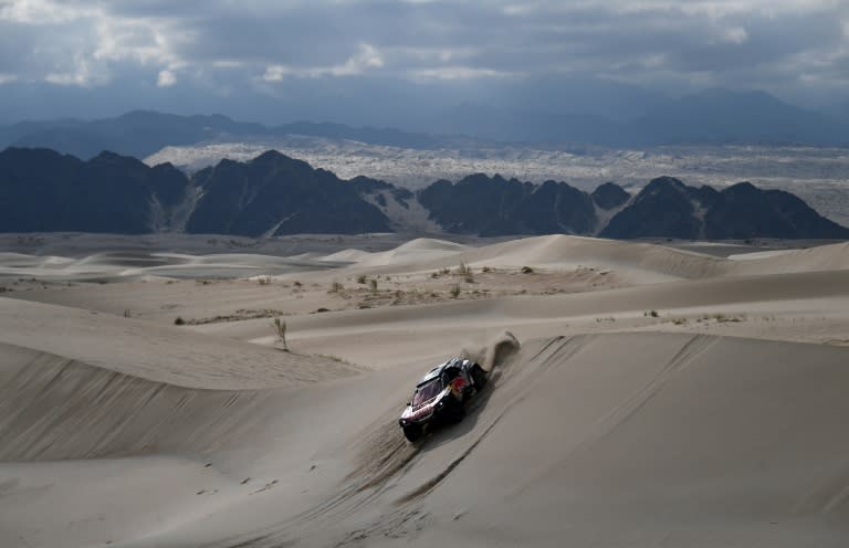 Peugeot's drivers Carlos Sainz and Lucas Cruz compete during the Stage 11 of the 2018 Dakar Rally on January 17, 2018