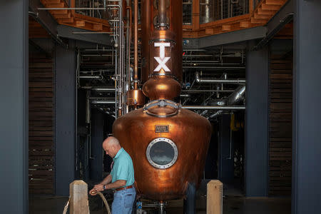 Co-founder Leonard Firestone opens passage to the beer still at the Firestone & Robertson (F&R) Whiskey Ranch in Forth Worth, Texas, U.S., May 24, 2018. REUTERS/Adrees Latif