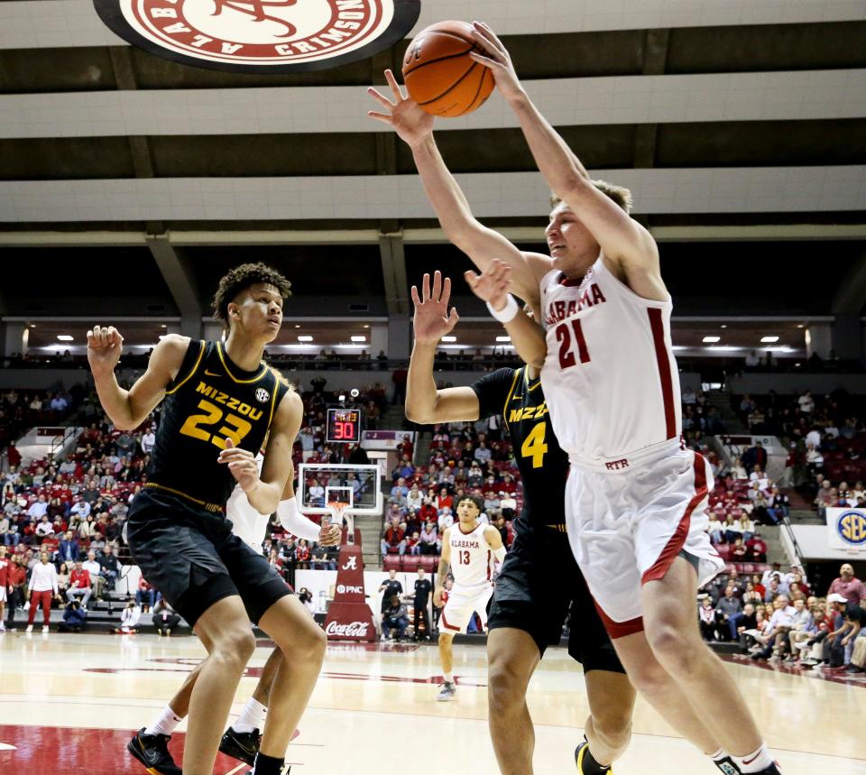 Alabama guard Britton Johnson (21) saves a ball from going out of bounds against Missouri forward Trevon Brazile (23) and Missouri guard Javon Pickett (4) in Coleman Coliseum Saturday, Jan. 22, 2022. 