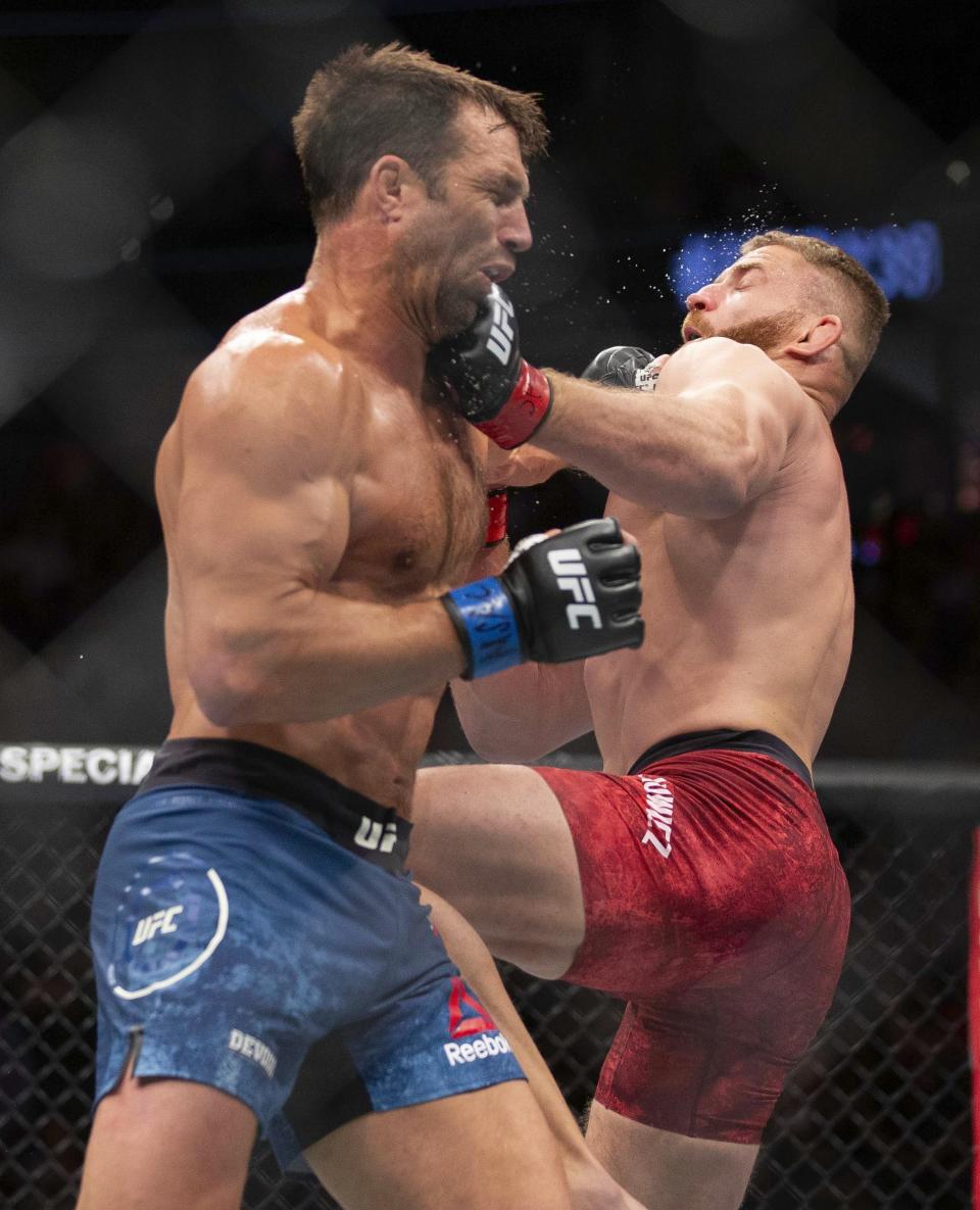 Jan Blachowicz, left, trades punches with Luke Rockhold during their light heavyweight mixed martial arts bout at UFC 239, Saturday, July 6, 2019, in Las Vegas. Blachowicz won by knockout. (AP Photo/Eric Jamison)