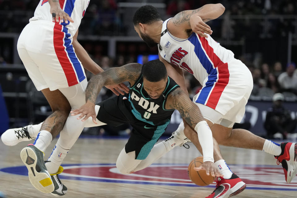 Portland Trail Blazers guard Damian Lillard (0) loses control of the ball next to Detroit Pistons guard Cory Joseph (18) during the first half of an NBA basketball game, Monday, March 6, 2023, in Detroit. (AP Photo/Carlos Osorio)