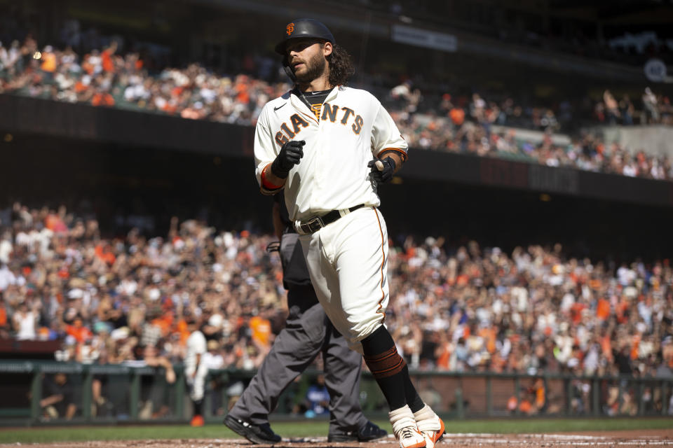 San Francisco Giants' Brandon Crawford scores on Kris Bryant's single against the San Diego Padres during the second inning of a baseball game, Saturday, Oct. 2, 2021, in San Francisco. (AP Photo/D. Ross Cameron)