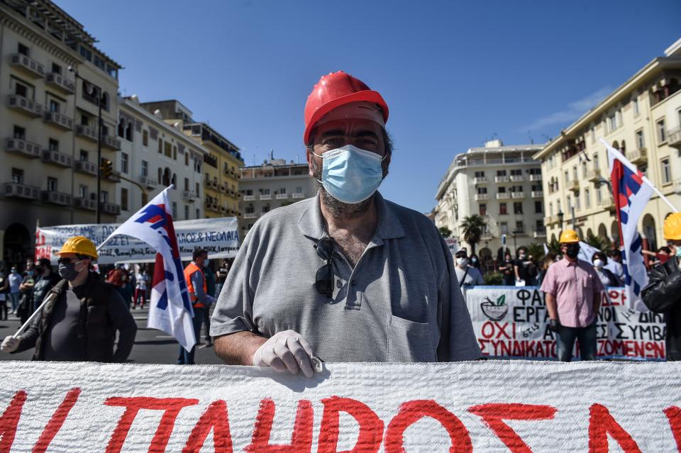 A member of the Greek Labour Union (PAME), wearing a protective mask against the spread of the novel coronavirus, COVID-19,  protest during the Labour Day demonstration in Thessaloniki on May 1, 2020, as the Greek government asked unions to delay public rallies by more than a week, but leading union GSEE called for a general strike to coincide with May Day. - Workers were forced to scale back May Day rallies around the world on May 1, 2020, because of coronavirus lockdowns, although some pushed on with online events and others hit the streets in face masks. (Photo by Sakis MITROLIDIS / AFP) (Photo by SAKIS MITROLIDIS/AFP via Getty Images)