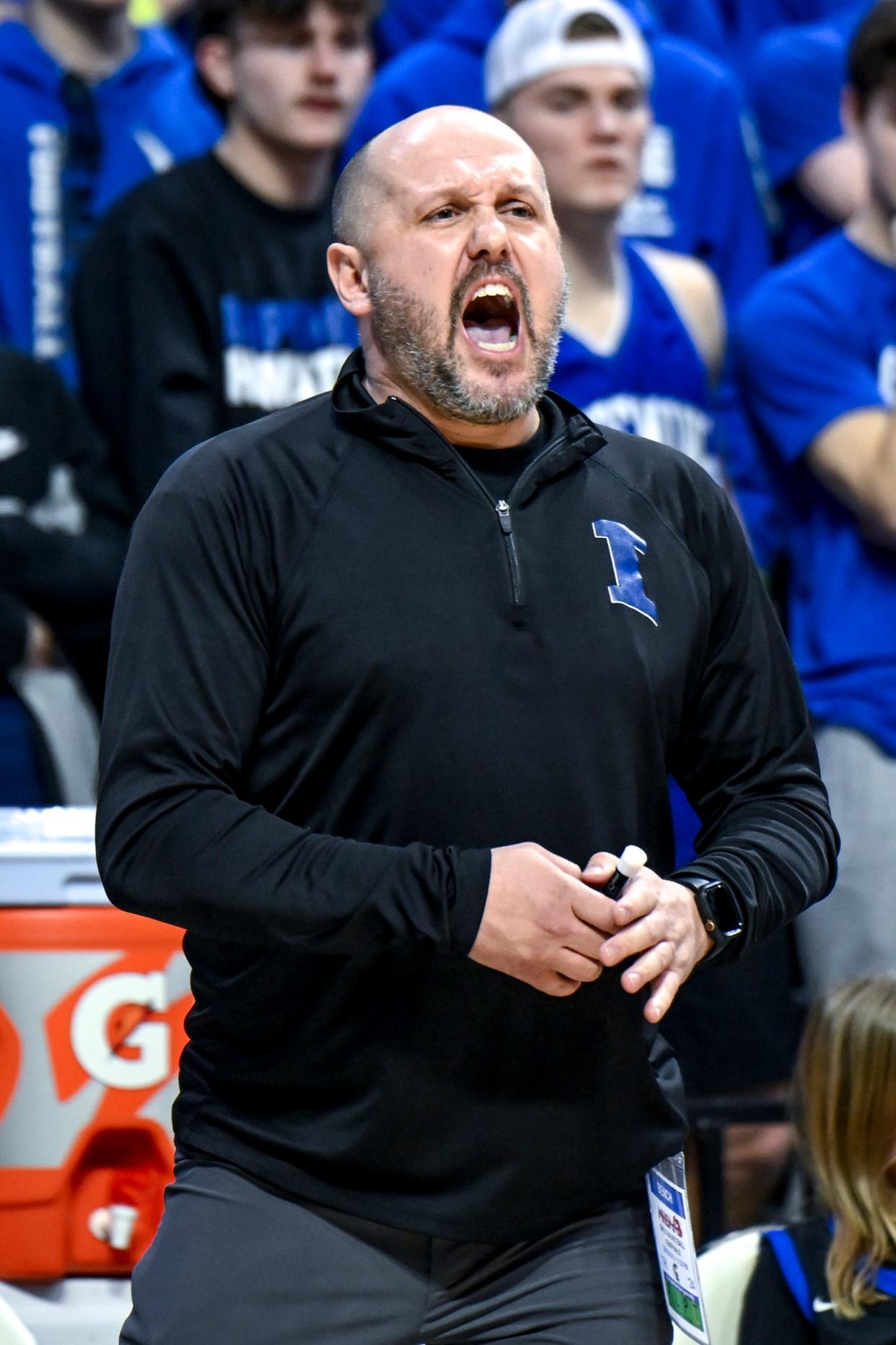 Ishpeming's head coach Ryan Reichel calls out to players during the first quarter in the Division 4 girls basketball state semifinal against Fowler on Thursday, March 21, 2024, at the Breslin Center in East Lansing.