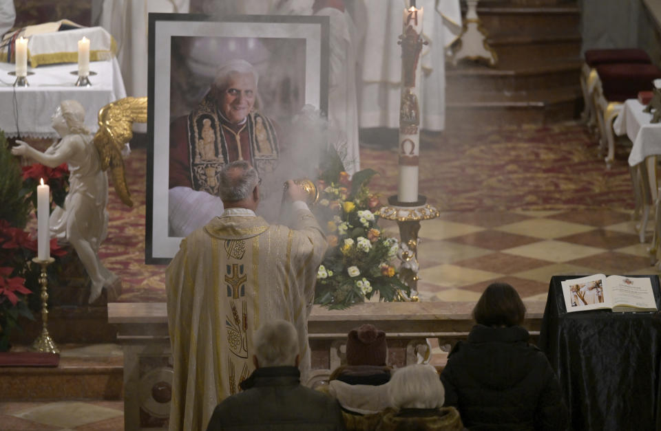 Believers and clergy attend a mass for Pope Emeritus Benedict XVI at the Saint Magdalena church in Altoetting, Germany, Saturday, Dec. 31, 2022. Pope Emeritus Benedict XVI, the German theologian who will be remembered as the first pope in 600 years to resign, has died, the Vatican announced Saturday. He was 95. (AP Photo/Andreas Schaad)