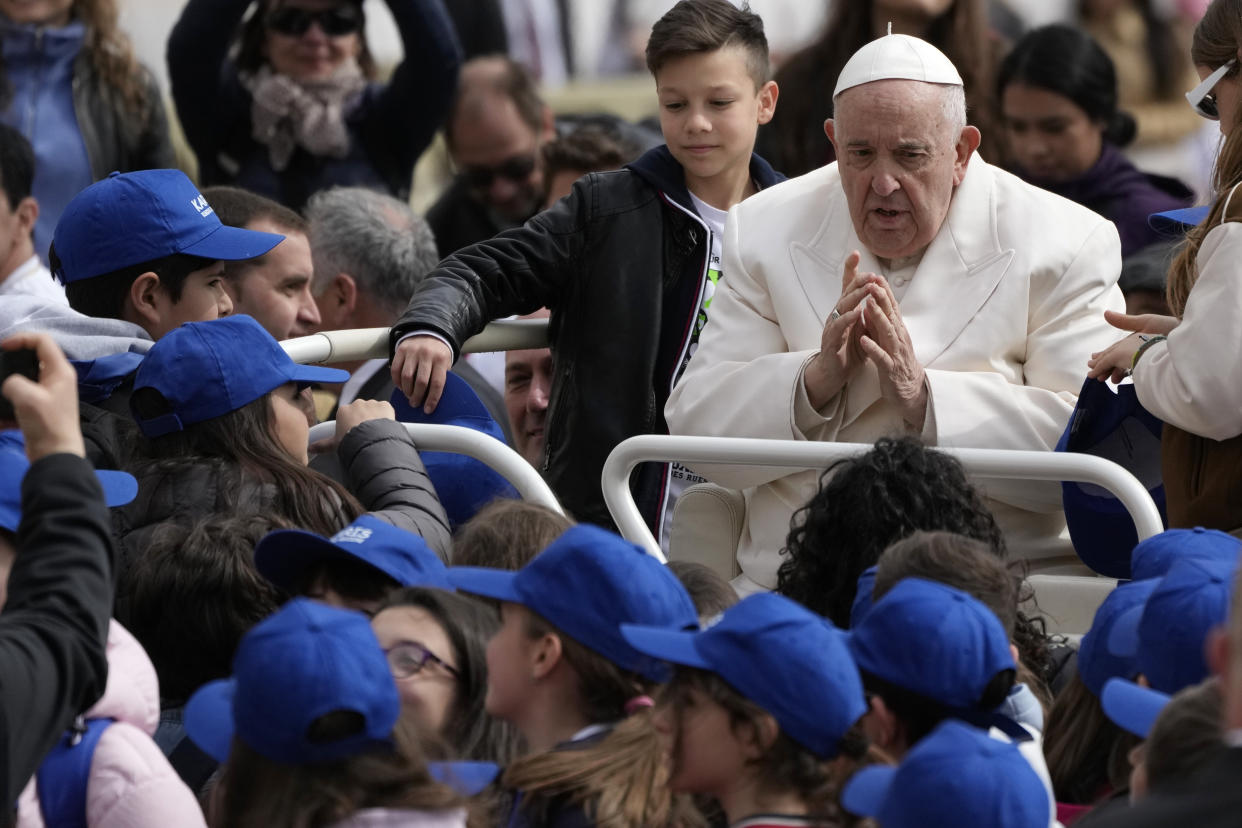 Pope Francis meets children at the end of his weekly general audience in St. Peter's Square, at the Vatican, Wednesday, March 29, 2023. (AP Photo/Alessandra Tarantino)