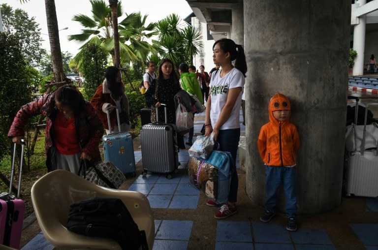 Stranded Chinese tourists waiting for information at Surat Thani airport after tour operators suspended boats to resort islands due to tropical storm Pabuk