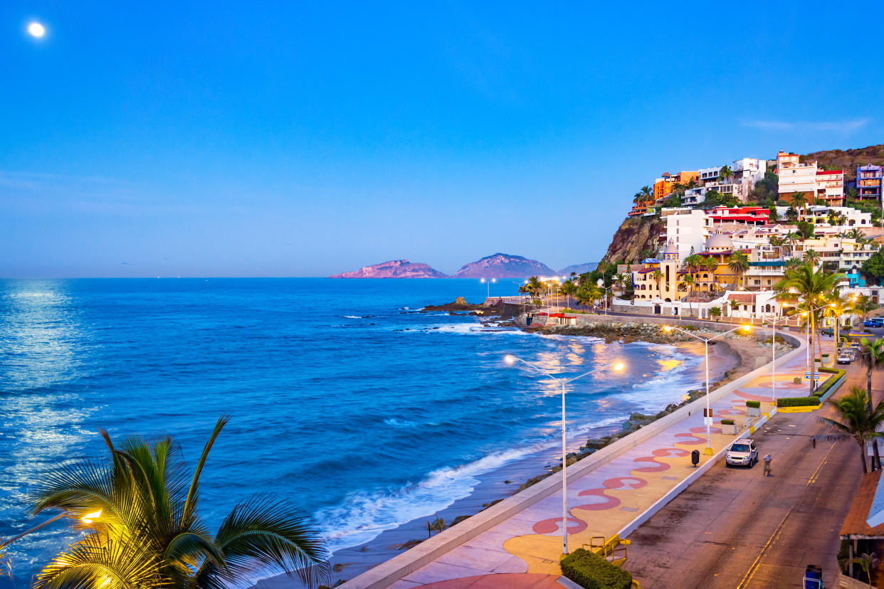 Stock photograph of beach and waterfront promenade in Mazatlan, Sinaloa, Mexico at twilight blue hour.