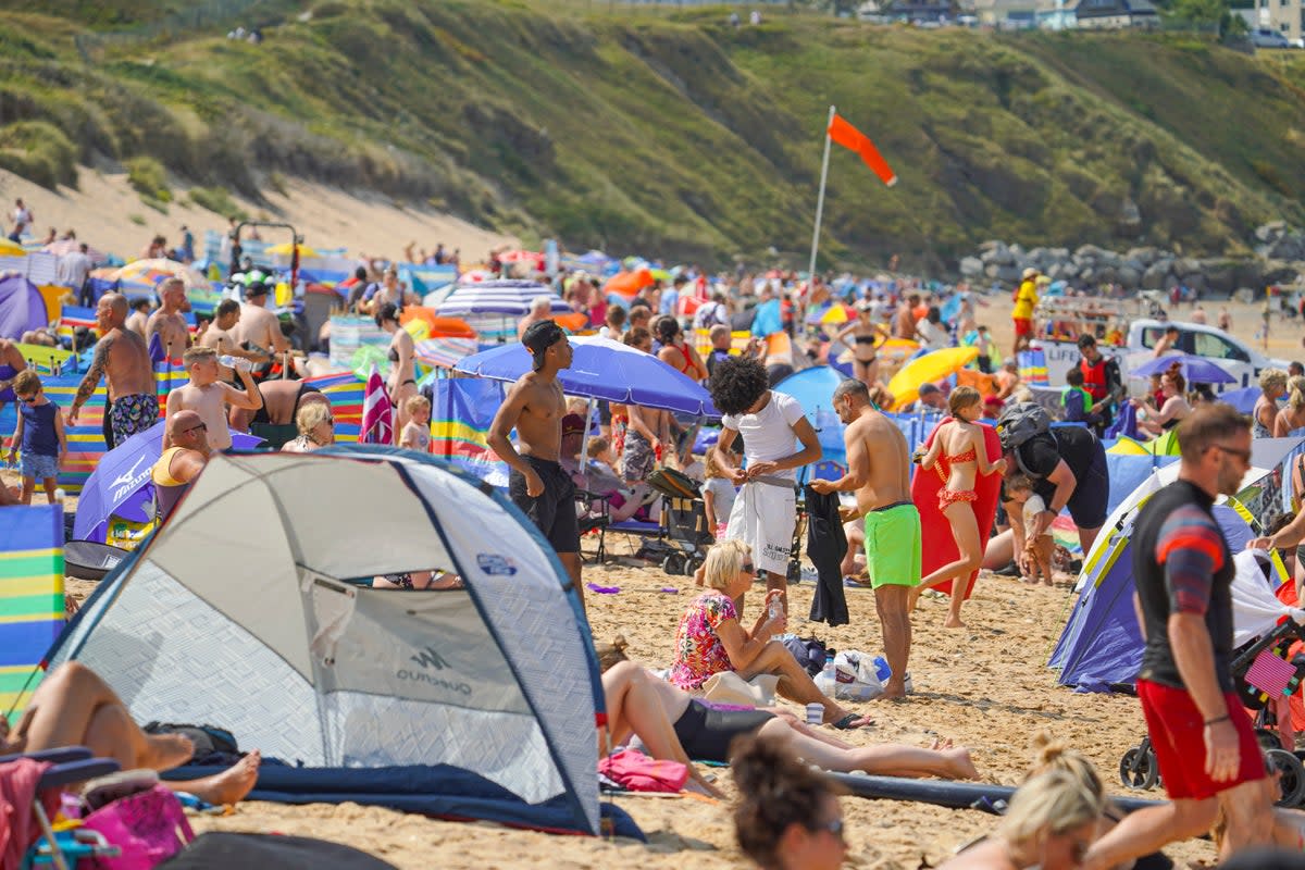 Holidaymakers fill the beach in Newquay - but an inquiry report by Cornwall Council says a spike in visitors can have a negative impact (Getty Images)