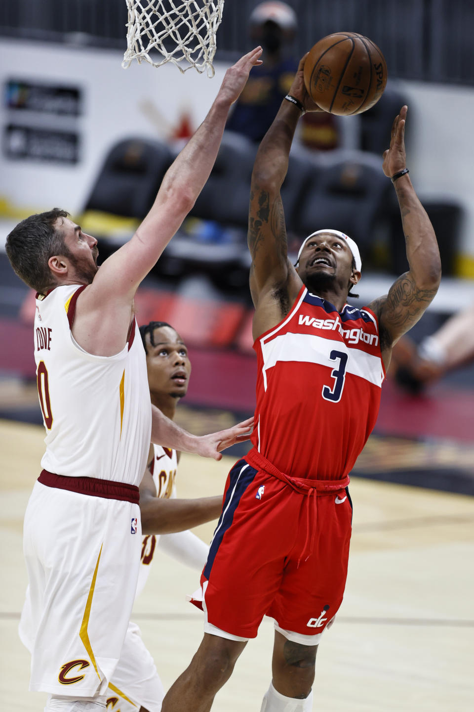 Washington Wizards' Bradley Beal (3) shoots against Cleveland Cavaliers' Kevin Love (0) during the second half of an NBA basketball game, Friday, April 30, 2021, in Cleveland. (AP Photo/Ron Schwane)