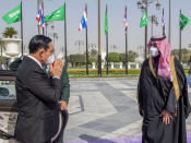 In this photo released by the Saudi Royal Palace, Saudi Crown Prince Mohammed bin Salman, right, receives Thai Prime Minister Prayuth Chan-ocha, at the royal palace in Riyadh, Saudi Arabia, Tuesday, Jan. 25, 2022. Thailand's prime minister arrived in Saudi Arabia on Tuesday for the first high-level meeting since relations between the nations soured three decades ago over a sensational jewelry heist that led to a diplomatic row and string of mysterious killings. (Bandar Aljaloud/Saudi Royal Palace via AP)