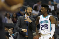 Charlotte Hornets coach James Borrego discusses a play with Kobi Simmons during the first half of an NBA preseason basketball game in Charlotte, N.C., Wednesday, Oct. 16, 2019. (AP Photo/Bob Leverone)