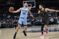 Memphis Grizzlies guard John Konchar (46) is defended by Washington Wizards guard Tyus Jones (5) during the first half of an NBA basketball game Tuesday, March 12, 2024, in Memphis, Tenn. (AP Photo/Nikki Boertman)