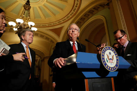 Senate Majority Leader Mitch McConnell, accompanied by Sen. Roy Blunt (R-MO), speaks with reporters following the party luncheons on Capitol Hill in Washington, U.S. November 14, 2017. REUTERS/Aaron P. Bernstein