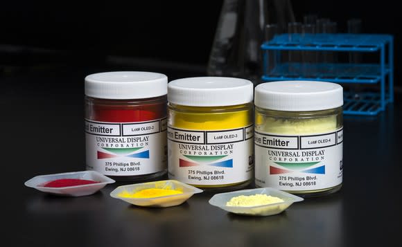 Three jars containing red, blue, and green phosphorescent OLED material with Universal Display logo