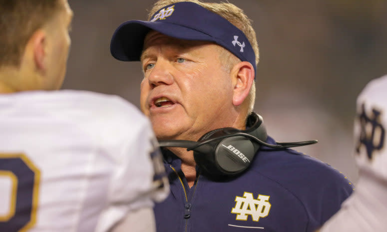 A closeup of Notre Dame football coach Brian Kelly talking to his players.