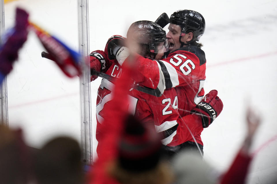 New Jersey Devils' Seamus Casey, left, celebrates with New Jersey Devils' Erik Haula after scoring his sides first goal during the NHL hockey game between Buffalo Sabres and New Jersey Devils, in Prague, Czech Republic, Saturday, Oct. 5, 2024. (AP Photo/Petr David Josek)