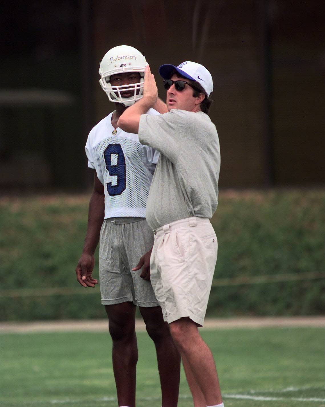 Mike Leach works with wide receiver Jimmy Robinson during a UK practice in 1997. Leach spent one season as wide receivers coach and one as offensive coordinator at Kentucky before leaving after the 1998 season to become offensive coordinator at Oklahoma.