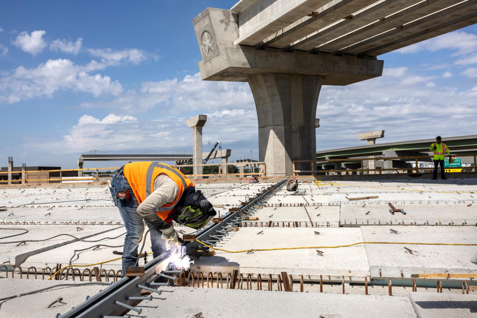 A welder works on an overpass on the Irving Interchange infrastructure project in Irving, Texas