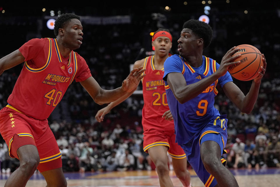 West center Flory Bidunga (40) defends East guard Drake Powell (9) during the fourth quarter of the McDonald's All-American boys' basketball game Tuesday, April 2, 2024, in Houston. (AP Photo/Kevin M. Cox)