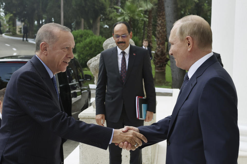 In this photo provided by the Turkish Presidency, Russian President Vladimir Putin, right, welcomes Turkish President Recep Tayyip Erdogan prior to their meeting at the Rus Sanatorium in the Black Sea resort of Sochi, Russia, Friday, Aug. 5, 2022. (Turkish Presidency via AP)