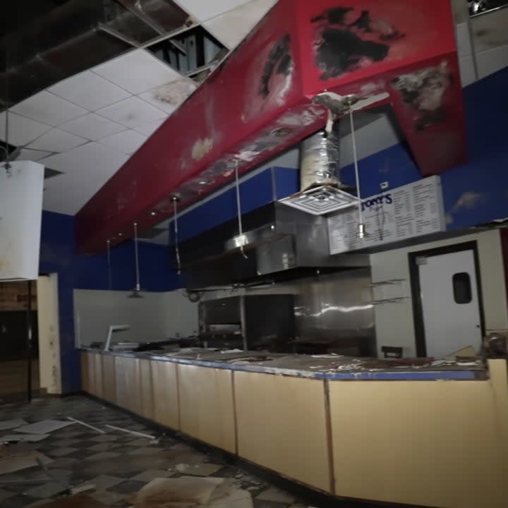 An abandoned fast food place inside of a mall