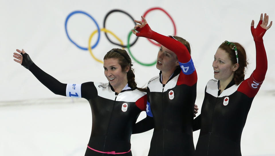 Canada's Ivanie Blondin (L-R), Brittany Schussler and Kali Christ wave after the women's speed skating team pursuit finals event at the Adler Arena in the Sochi 2014 Winter Olympic Games February 22, 2014. REUTERS/Issei Kato (RUSSIA - Tags: OLYMPICS SPORT SPEED SKATING)