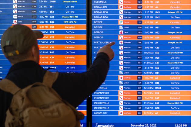 An information panel shows numerous canceled flights and delays at Reagan National Airport in Arlington, Virginia, on Thursday.