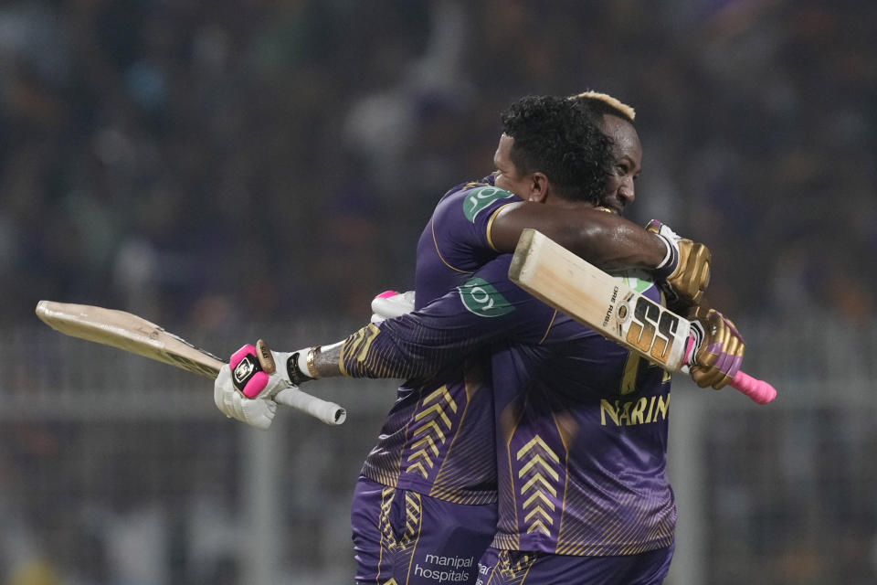 Kolkata Knight Riders' Andre Russell hugs Sunil Narine after latter scored a century during the Indian Premier League cricket match between Kolkata Knight Riders and Rajasthan Royals in Kolkata, India, Tuesday, April 16, 2024. (AP Photo/Bikas Das)